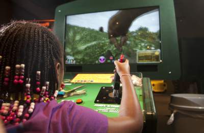 Video game being played in Be The Dinosaur Exhibit