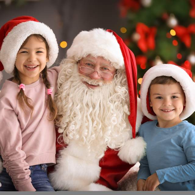 Kids taking a photo with Santa Claus
